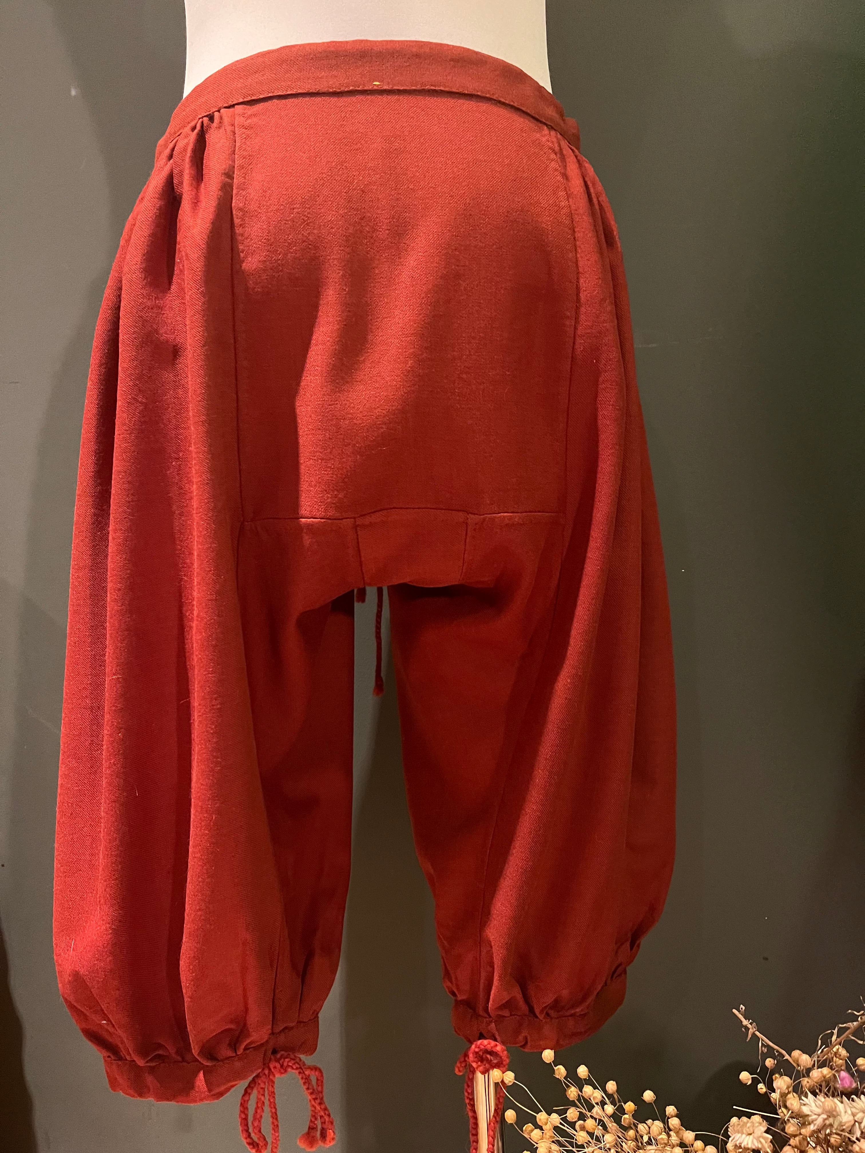 Back view of red Viking Hedeby pants with gathered cuffs