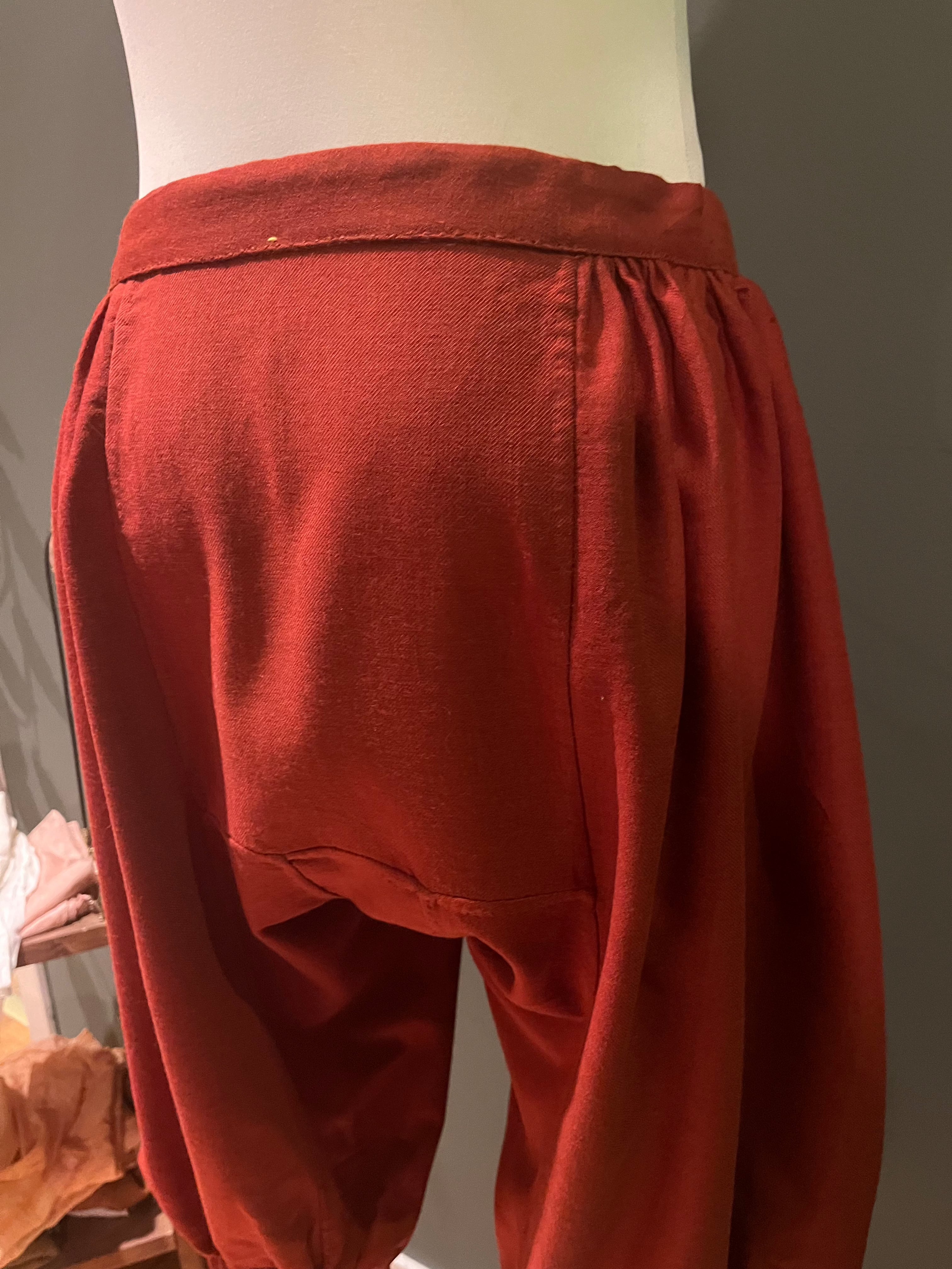 Side view of red woolen Viking pants