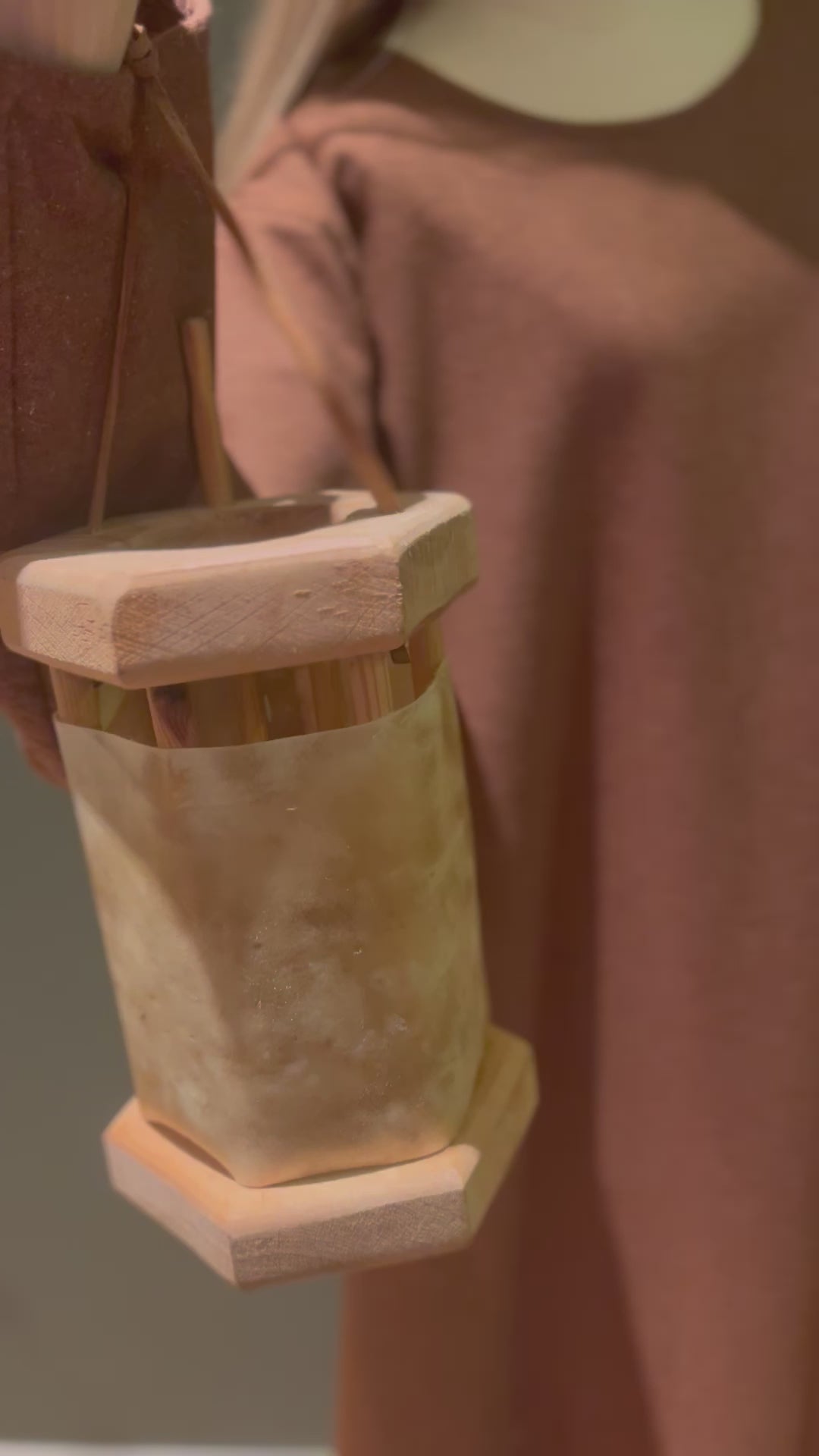 Close-up of wooden lantern with TYRA woolen dress