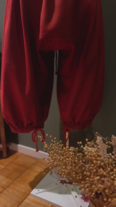 Red Viking pants with floral decor in foreground